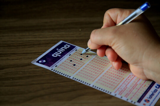 salvador, bahia, brazil - january 2, 2021: person scoring Quina lottery ticket in the city of Salvador.