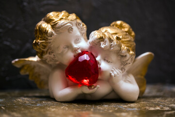 Angel statue. Valentine day. Gifts. Red heart. 