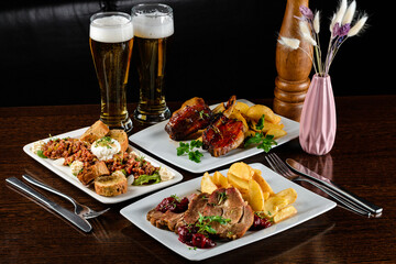 Dinner table with different dishes, three-course set on the table. Different food on a wooden table. Three course menu