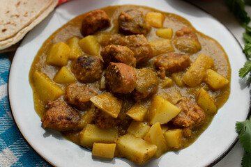 Mexican longaniza with green sauce and potato on white background