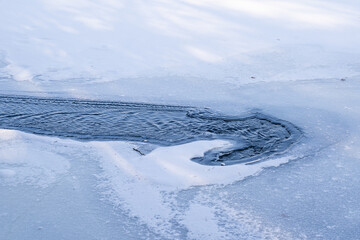 Frozen ice and running water pattern on the St Croix River in Minnesota