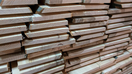 stack of rough sawn timber planks construction material, selective focus