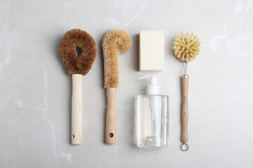 Flat lay composition with cleaning supplies for dish washing on grey table, flat lay