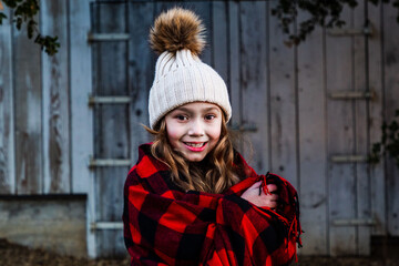 A little girl dressed in red on a winters day