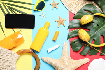 Flat lay composition with beach objects and smartphone on color background