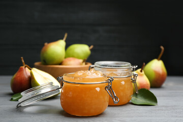 Delicious pear jam and fresh fruits on grey wooden table