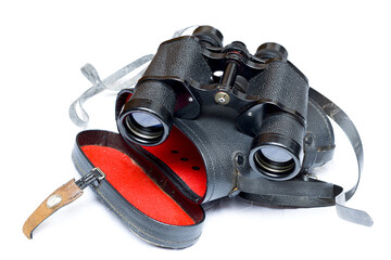 vintage binoculars on top of an antique book inside its cover with white background