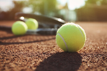 Tennis balls on clay court. Space for text