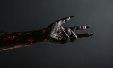 Scary monster on black background, closeup of hand. Halloween character © New Africa