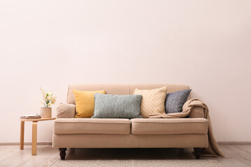 Simple room interior with comfortable beige sofa, space for text