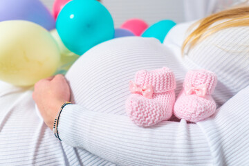 Pregnant woman belly and balloons isolated on white. Pregnancy concept.