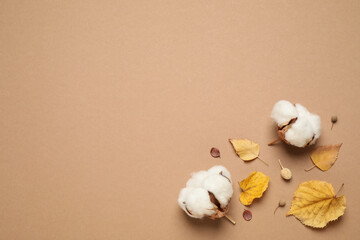 Flat lay composition with autumn leaves on beige background, space for text
