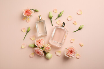 Flat lay composition with different perfume bottles and fresh flowers on beige background - obrazy, fototapety, plakaty