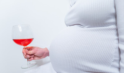 No alcohol during pregnancy. Young pregnant woman refuses to drink wine, making stop gesture to glass, free space
