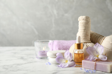 Spa composition with skin care products on white marble table, space for text