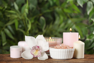 Fototapeta na wymiar Beautiful spa composition with sea salt and candles on wooden table