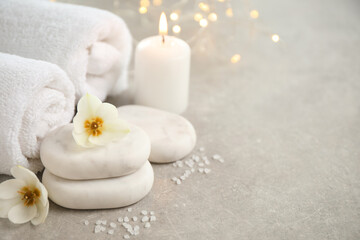 Spa composition with towels on light background, space for text