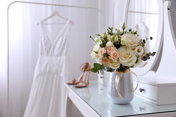 Beautiful wedding bouquet on dressing table indoors