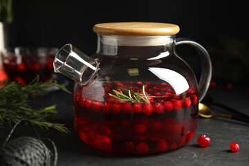 Tasty hot cranberry tea on black table