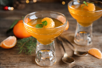 Delicious tangerine jelly on wooden table, closeup