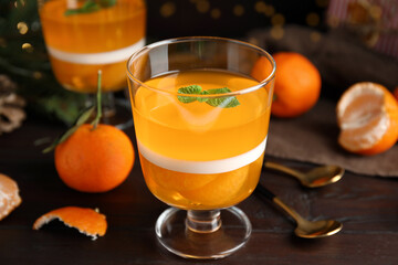 Delicious tangerine jelly on brown wooden table