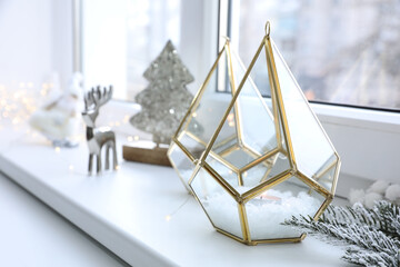 Beautiful glass candle holders and other Christmas decorations on window sill