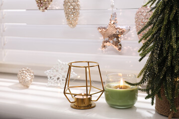 Beautiful candle holder and other Christmas decorations on window sill