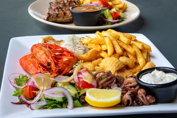 Seafood plate with king prawns and a side of salad and chips