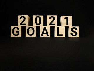 Obraz premium 2021 GOALS text on wooden blocks with black background. Business Concept. Stock photo.