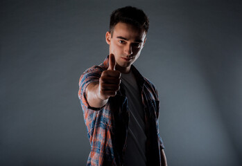 Cool handsome male model with thumbs up