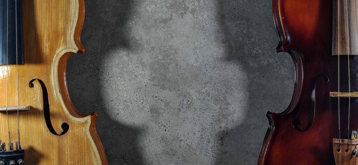 two violins on a gray background. violin with background space for text.