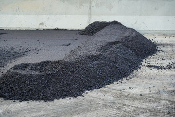The highway construction site is paving the new asphalt pavement.
