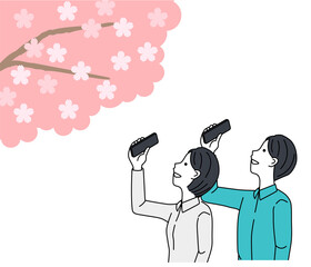 Man and woman taking pictures of cherry blossoms