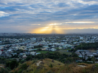 view of sun shinning over city in Sunset time