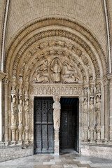 Fototapeta na wymiar Saint-Étienne Cathedral, Bourges, France. The south portal is from the 13th century. In the tympanum, Christ is surrounded by the symbols of the evangelists. In the pillar a Christ blessing.