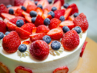 close up delicious strawberry and blueberry birthday cake