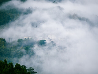 mist covering mountains and village
