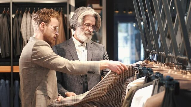 owner giving his customer the best suit that fits business people businessman office woman senior meeting men team elderly doctor young work smiling couple old happy businesswoman mature working job