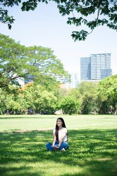 Portrait of young Asian feeling happy in the park.