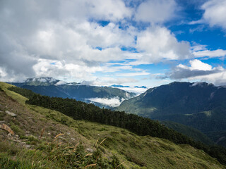Fototapeta premium Smoke and fog over the landscapes. beautiful mountains with blue sky, Mount Hehuan, Taiwan