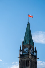 Peace Tower in Ottawa, Canada against blue sky with clouds