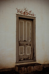 Old painted door against white wall 