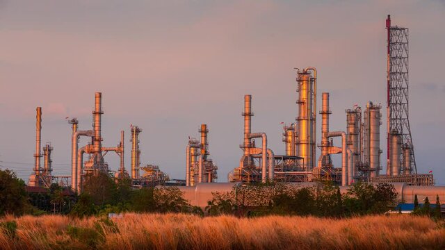 beautiful sunset view with crane, engineer, and worker work during maintenance period with big crane in petrochemical, petroleum, and refinery plant for repair and development project for fossil oil d