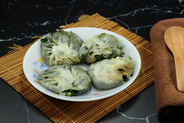 Pile of steamed chives dumpling serving on the plate. Famous classic dim sum menu in Chinese restaurant. 