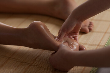 A beautiful young lady doing foot massage