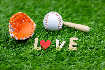 Baseball with love word on green grass for Valentine's Day 