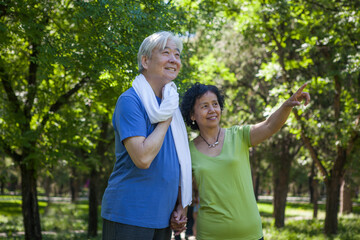 Two old people exercising in the park