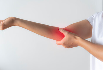 elbow pain, A woman was showing pain in her elbow.