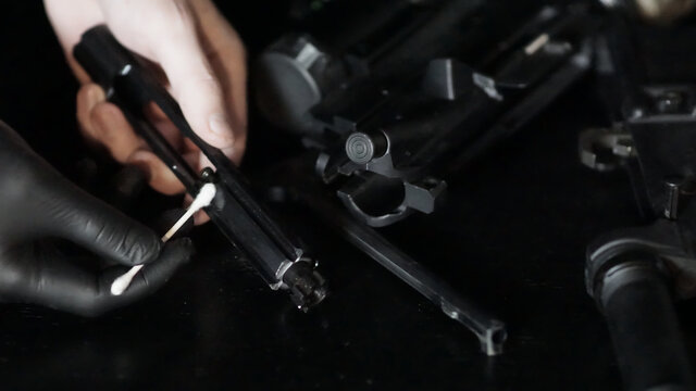 Armorer gunsmith repairing and maintaining an AR15 Rifle.