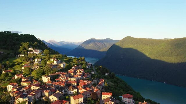 Aerial footage of the Monte Br&eacute; village by lake Lugano in Canton Ticino in Switzerland. Shot with a upward tilt down revealing effect. 
